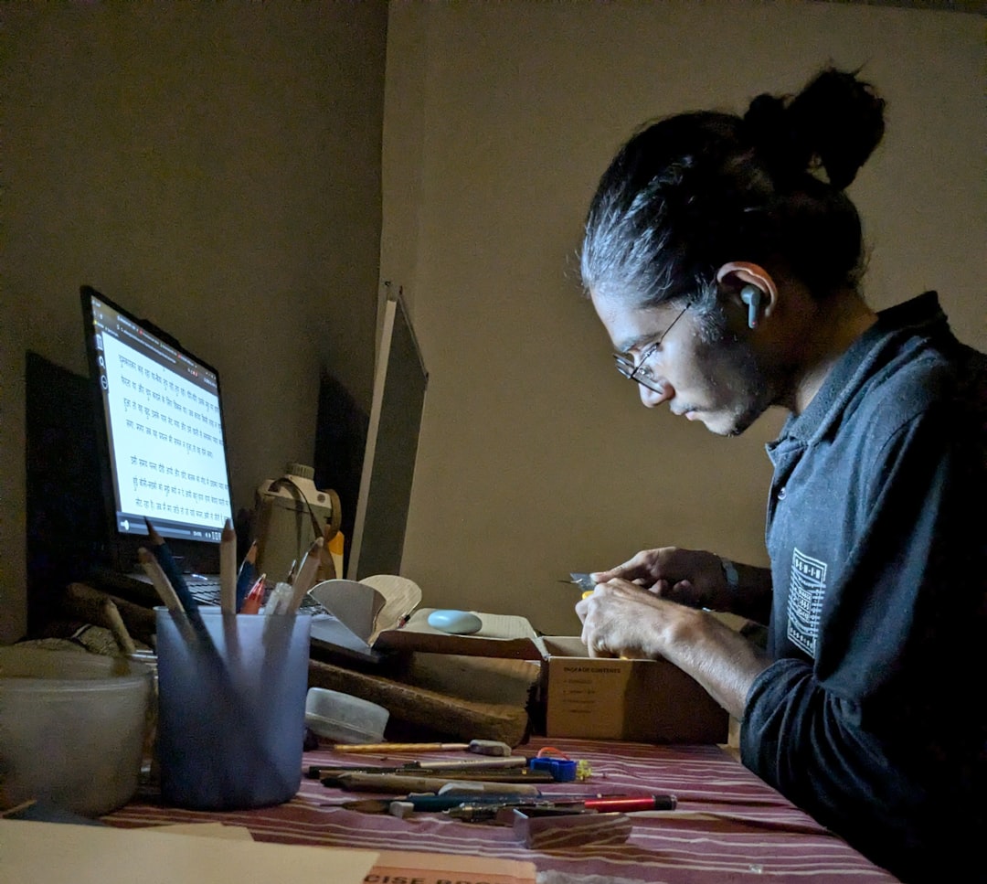 person writing at desk